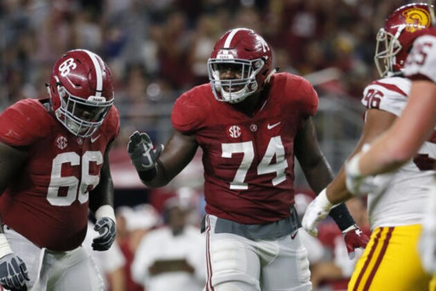 FILE - In this Sept. 3, 2016, file photo, Alabama offensive lineman Lester Cotton (66) and offensive lineman Cam Robinson (74) line up against Southern California during an NCAA college football game in Arlington, Texas. Robinson was selected to the 2016 AP All-America college football team, Monday, Dec. 12, 2016. (AP Photo/Tony Gutierrez, File)