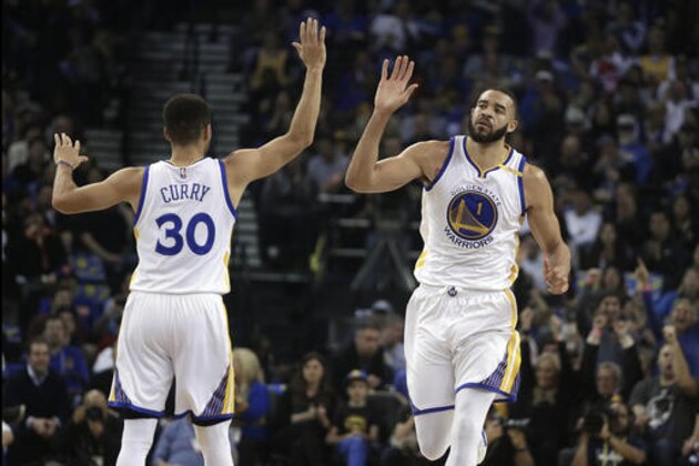 Golden State Warriors' JaVale McGee, right, celebrates a score with Stephen Curry (30) during the first half of an NBA basketball game against the New York Knicks Thursday, Dec. 15, 2016, in Oakland, Calif. (AP Photo/Ben Margot)