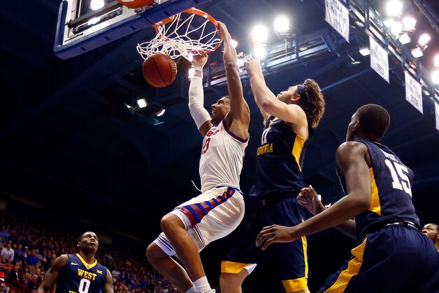 LAWRENCE, KS - FEBRUARY 13:  Landen Lucas #33 of the Kansas Jayhawks dunks as Nathan Adrian #11 of the West Virginia Mountaineers defends during the game at Allen Fieldhouse on February 13, 2017 in Lawrence, Kansas.  (Photo by Jamie Squire/Getty Images)