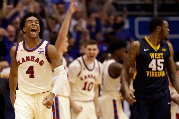 LAWRENCE, KS - FEBRUARY 13:  Devonte' Graham #4 of the Kansas Jayhawks celebrates after making a three-pointer late in the game against the West Virginia Mountaineers at Allen Fieldhouse on February 13, 2017 in Lawrence, Kansas.  (Photo by Jamie Squire/Getty Images)