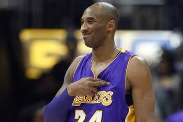 Los Angeles Lakers forward Kobe Bryant (24) gestures to someone in the crowd in the first half of an NBA basketball game against the Atlanta Hawks, Friday, Dec. 4, 2015, in Atlanta. Bryant has said he plans to retire at the end of the season. (AP Photo/John Bazemore)