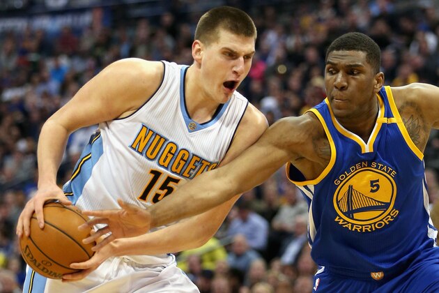 DENVER, CO - FEBRUARY 13: Nikola Jokic #15 of the Denver Nuggets drives to the basket against Kevin Looney #5 of the Golden State Warriors at the Pepsi Center on February 13, 2017 in Denver, Colorado. NOTE TO USER: User expressly acknowledges and agrees that , by downloading and or using this photograph, User is consenting to the terms and conditions of the Getty Images License Agreement.  (Photo by Matthew Stockman/Getty Images)