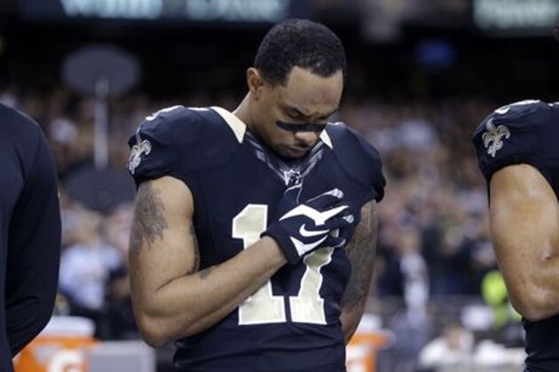 New Orleans Saints wide receiver Robert Meachem (17) holds his hand to his hearts during the National Anthem before an NFL football game against the Atlanta Falcons in New Orleans, Sunday, Dec. 21, 2014. (AP Photo/Gerald Herbert)