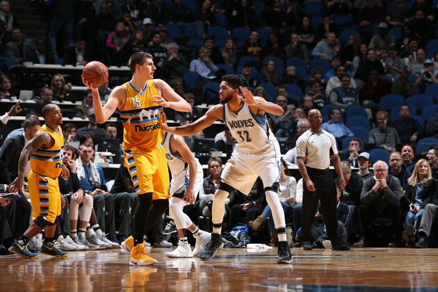 MINNEAPOLIS, MN - JANUARY 22:  Nikola Jokic #15 of the Denver Nuggets handles the ball against Karl-Anthony Towns #32 of the Minnesota Timberwolves during a game on January 22, 2017 at the Target Center in Minneapolis, Minnesota. NOTE TO USER: User expressly acknowledges and agrees that, by downloading and/or using this photograph, user is consenting to the terms and conditions of the Getty Images License Agreement. Mandatory Copyright Notice: Copyright 2017 NBAE (Photo by David Sherman/NBAE via Getty Images)