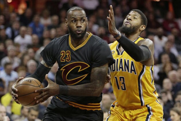 Cleveland Cavaliers' LeBron James (23) drives against Indiana Pacers' Paul George (13) in the first half of an NBA basketball game, Wednesday, Feb. 15, 2017, in Cleveland. (AP Photo/Tony Dejak)