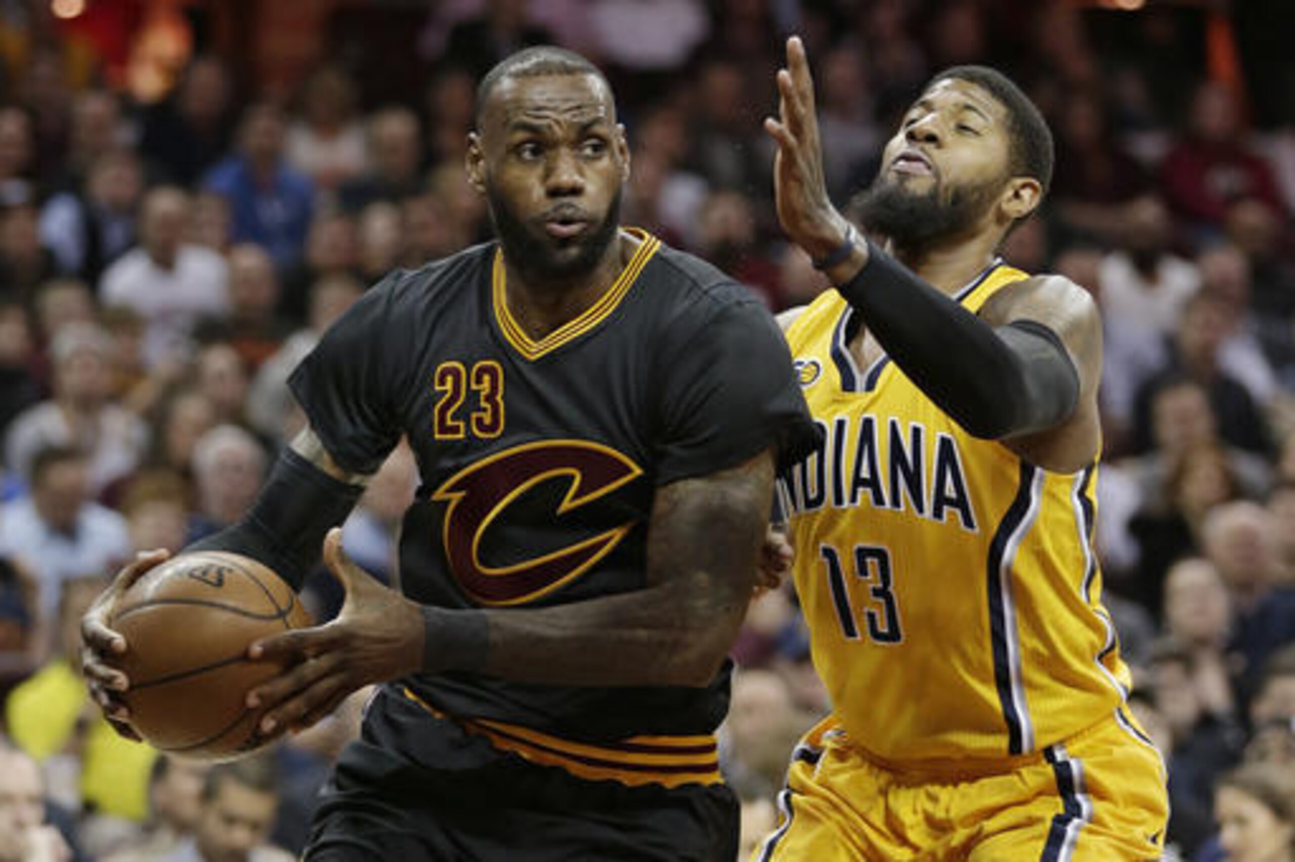 Cleveland Cavaliers' LeBron James (23) drives against Indiana Pacers' Paul George (13) in the first half of an NBA basketball game, Wednesday, Feb. 15, 2017, in Cleveland. (AP Photo/Tony Dejak)