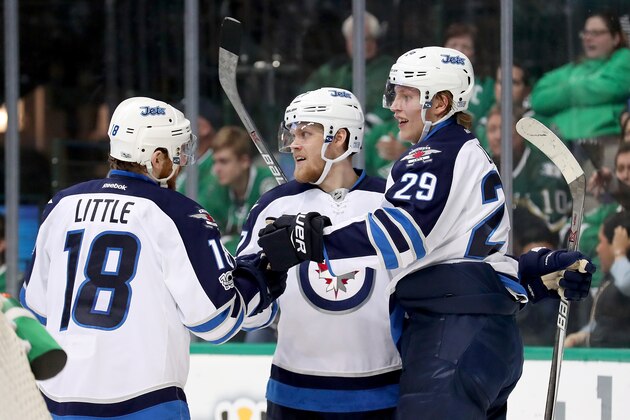 DALLAS, TX - FEBRUARY 02:  Nikolaj Ehlers #27 of the Winnipeg Jets celebrates with Patrik Laine #29 of the Winnipeg Jets and Bryan Little #18 of the Winnipeg Jets after scoring a goal against Kari Lehtonen #32 of the Dallas Stars in the second period at American Airlines Center on February 2, 2017 in Dallas, Texas.  (Photo by Tom Pennington/Getty Images)