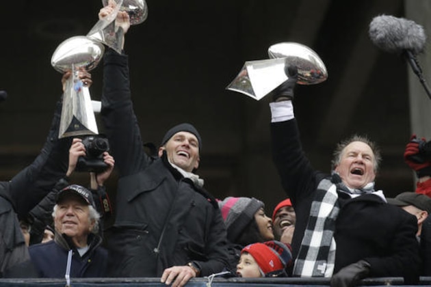New England Patriots quarterback Tom Brady holds up Super Bowl trophies along with head coach Bill Belichick, right, and team owner Robert Kraft, left, during a rally Tuesday, Feb. 7, 2017, in Boston, to celebrate Sunday's 34-28 win over the Atlanta Falcons in the NFL Super Bowl 51 football game in Houston. (AP Photo/Elise Amendola)