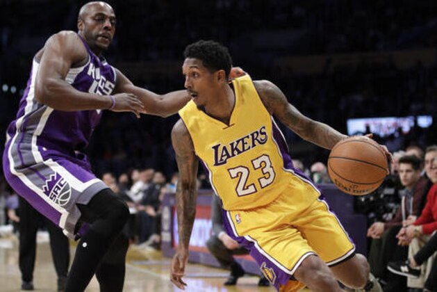Los Angeles Lakers' Lou Williams, right, drives past Sacramento Kings' Anthony Tolliver during the first half of an NBA basketball game, Tuesday, Feb. 14, 2017, in Los Angeles. (AP Photo/Jae C. Hong)