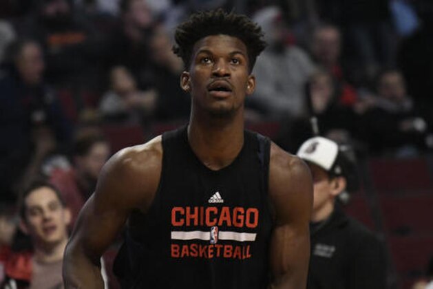 Chicago Bulls forward Jimmy Butler (21) warms up before the start of the game against the Miami Heat during an NBA basketball game in Chicago, Friday, Jan. 27, 2017. Butler was taken out of the starting lineup for comments he made after a loss, (AP Photo/David Banks)