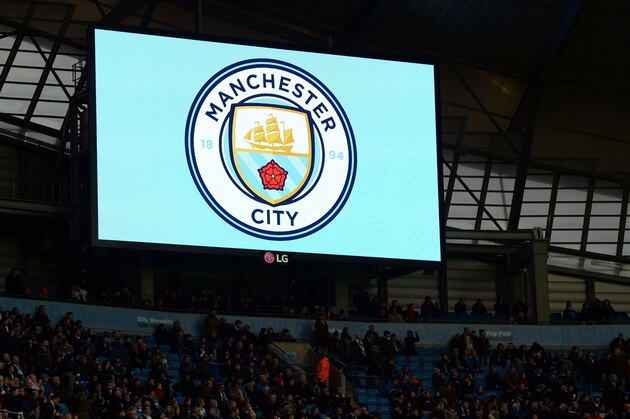 Manchester City unveil their new badge design before the English Premier League football match between Manchester City and Sunderland at The Etihad stadium in Manchester, north west England on December 26, 2015. Manchester City won the game 4-1. AFP PHOTO / OLI SCARFF

RESTRICTED TO EDITORIAL USE. No use with unauthorized audio, video, data, fixture lists, club/league logos or 'live' services. Online in-match use limited to 75 images, no video emulation. No use in betting, games or single club/league/player publications. / AFP / OLI SCARFF        (Photo credit should read OLI SCARFF/AFP/Getty Images)