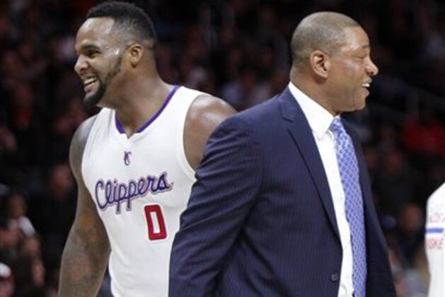 Los Angeles Clippers forward Glen Davis (0) and Los Angeles Clippers head coach Doc Rivers, right, laugh after a time out is called in the second half of an NBA basketball game against the Detroit Pistons in Los Angeles, Monday, Dec. 15, 2014. The Clippers won 113-91. (AP Photo/Alex Gallardo)