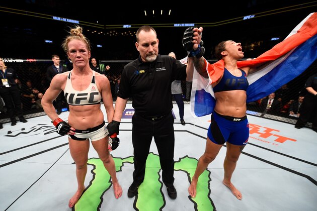 BROOKLYN, NEW YORK - FEBRUARY 11:  (R-L) Germaine de Randamie of The Netherlands celebrates her victory over Holly Holm in their women's featherweight championship bout during the UFC 208 event inside Barclays Center on February 11, 2017 in Brooklyn, New York. (Photo by Jeff Bottari/Zuffa LLC/Zuffa LLC via Getty Images)
