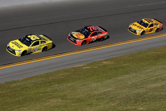 DAYTONA BEACH, FL - FEBRUARY 21: Matt Kenseth, driver of the #20 Dollar General Toyota, leads Martin Truex Jr., driver of the #78 Bass Pro Shops/Tracker Boats Toyota, and Kyle Busch, driver of the #18 M&M's 75 Toyota, during the NASCAR Sprint Cup Series DAYTONA 500 at Daytona International Speedway on February 21, 2016 in Daytona Beach, Florida.  (Photo by Sean Gardner/Getty Images)