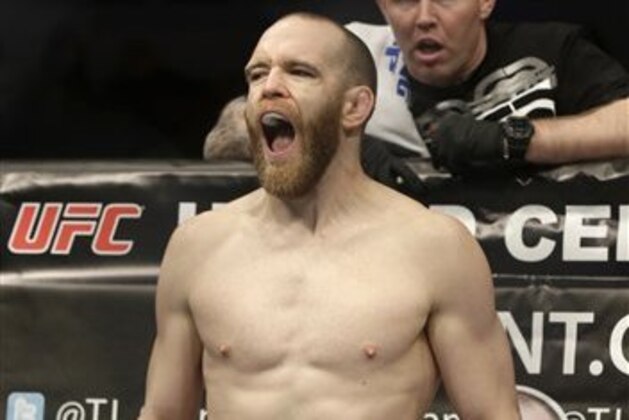 TJ Grant stands before fighting with Matt Wiman during UFC Lightweight Championship on FOX 6 at the United Center in Chicago, Saturday, Jan. 26, 2013. Grant won the bout. (AP Photo/Nam Y. Huh)