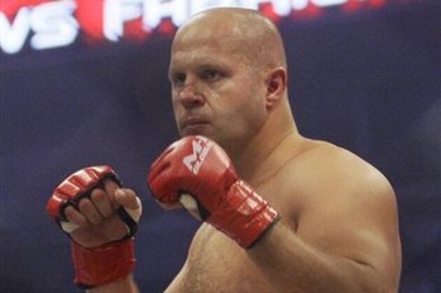 FILE - In this June 26, 2010, file photo, Fedor Emelianenko, of Russia, fights Fabricio Werdum in a Strikeforce/M-1 Global mixed martial arts match in San Jose, Calif. Emelianenko doesn't speak a lick of English. He rarely smiles. When he steps inside a ring or cage, he looks like he's bored, like he'd rather be reading a book. Here's why fans wait hours to see him, though: He just may be the best heavyweight fighter ever. (AP Photo/Jeff Chiu, File)