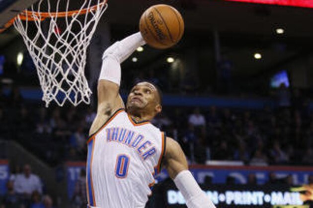 Oklahoma City Thunder guard Russell Westbrook (0) goes up for a dunk in front of New York Knicks forward Kristaps Porzingis (6) during the fourth quarter of an NBA basketball game in Oklahoma City, Wednesday, Feb. 15, 2017. Oklahoma City won 116-105. (AP Photo/Sue Ogrocki)