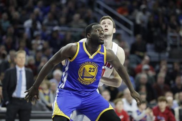 Golden State Warriors forward Draymond Green watches a free throw during the second half of an NBA basketball game against the Detroit Pistons, Friday, Dec. 23, 2016, in Auburn Hills, Mich. (AP Photo/Carlos Osorio)