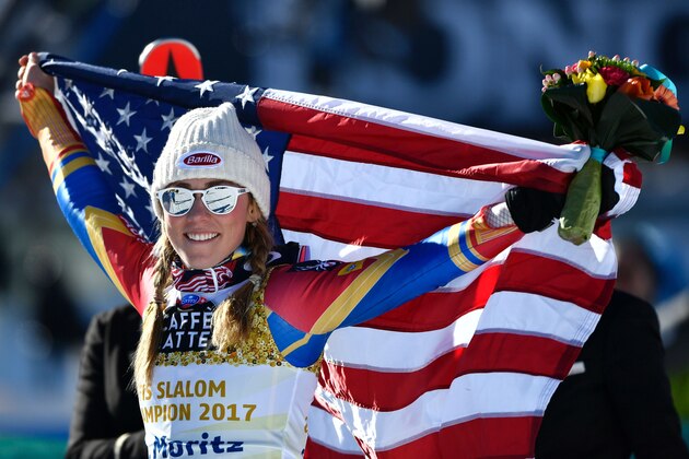 US skier Mikaela Shiffrin holds a US flag as she celebrates winning the women's slalom race at the 2017 FIS Alpine World Ski Championships in St Moritz on February 18, 2017. / AFP / Fabrice COFFRINI        (Photo credit should read FABRICE COFFRINI/AFP/Getty Images)