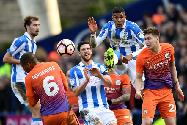 HUDDERSFIELD, ENGLAND - FEBRUARY 18: John Stones of Manchester City (R) heads the ball towards goal during The Emirates FA Cup Fifth Round match between Huddersfield Town and Manchester City at John Smith's Stadium on February 18, 2017 in Huddersfield, England.  (Photo by Laurence Griffiths/Getty Images)