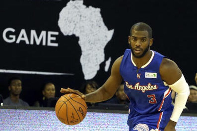 FILE - In this Aug. 1, 2015 file photo, Team World's Chris Paul of Los Angeles Clippers drives the ball against Team Africa during the NBA Africa Game at Ellis Park Arena in Johannesburg, South Africa, Saturday, Aug. 1, 2015. The NBA is making a new play for fans in Africa by splitting with the continent’s biggest sports broadcaster and teaming up with a Zimbabwean telecommunications entrepreneur who started his first business with $75.  (AP Photo/Themba Hadebe, File)