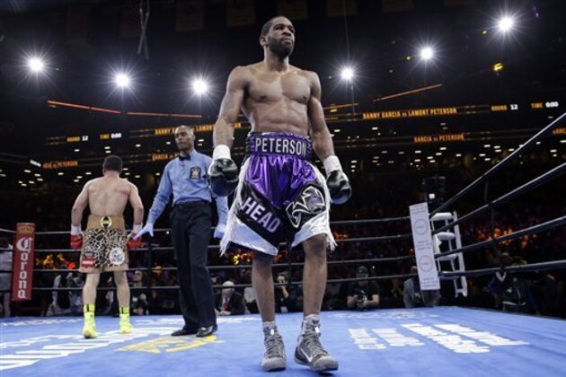 Referee Harvey Dock, center, sends Danny Garcia, left, and Lamont Peterson to their corners in the 12th round during a super lightweight boxing match, Saturday, April 11, 2015, in New York. Garcia won by a majority decision. (AP Photo/Mary Altaffer)