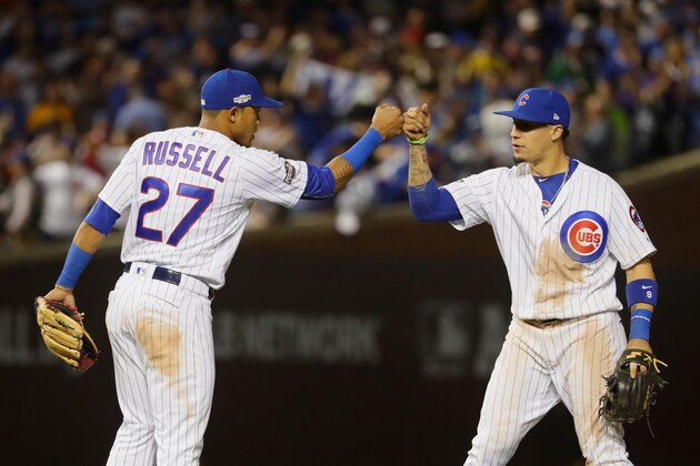 CHICAGO, IL - OCTOBER 15:  Addison Russell #27 of the Chicago Cubs celebrates with Javier Baez #9 after defeating the Los Angeles Dodgers 8-4 in game one of the National League Championship Series at Wrigley Field on October 15, 2016 in Chicago, Illinois.  (Photo by Jamie Squire/Getty Images)
