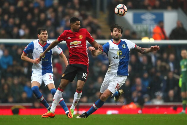 BLACKBURN, ENGLAND - FEBRUARY 19:  Marcus Rashford of Manchester United competes with Charlie Mulgrew of Blackburn Rovers during the Emirates FA Cup Fifth Round match between Blackburn Rovers and Manchester United at Ewood Park on February 19, 2017 in Blackburn, England.  (Photo by Matthew Ashton - AMA/Getty Images)