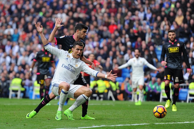 MADRID, SPAIN - FEBRUARY 18:  Cristiano Ronaldo of Real Madrid is tackled by Aaron Martin of RCD Espanyol  during the La Liga match between Real Madrid CF and RCD Espanyol at the Bernabeu stadium on February 18, 2017 in Madrid, Spain.  (Photo by Denis Doyle/Getty Images)