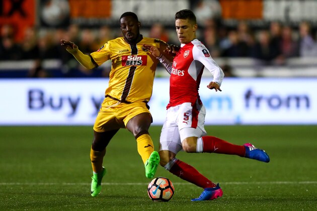 SUTTON, GREATER LONDON - FEBRUARY 20:  Gabriel Paulista of Arsenal battles for the ball with Roarie Deacon of Sutton United during the Emirates FA Cup fifth round match between Sutton United and Arsenal on February 20, 2017 in Sutton, Greater London.  (Photo by Clive Rose/Getty Images)