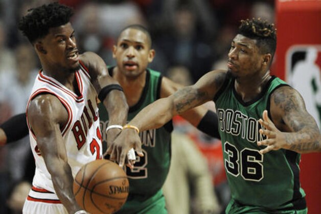 Chicago Bulls' Jimmy Butler (21) passes against Boston Celtics' Marcus Smart (36) during the second half of an NBA basketball game Thursday, Feb. 16, 2017, in Chicago. Chicago won 104-103. (AP Photo/Paul Beaty)