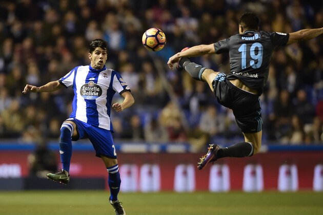 Deportivo La Coruna's defender Juanfran Moreno (L) vies with Real Sociedad's defender Yuri Berchiche during the Spanish league football match RC Deportivo de la Coruna vs Real Sociedad at the Municipal de Riazor stadium in La Coruna on December 5, 2016. / AFP / MIGUEL RIOPA        (Photo credit should read MIGUEL RIOPA/AFP/Getty Images)