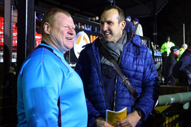 SUTTON, GREATER LONDON - FEBRUARY 20: Wayne Shaw of Sutton United talks to goalkeeper Mark Schwarzer  before The Emirates FA Cup Fifth Round match between Sutton United and Arsenal on February 20, 2017 in Sutton, Greater London. (Photo by Catherine Ivill - AMA/Getty Images)