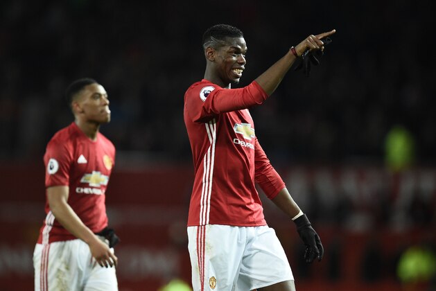 Manchester United's French striker Anthony Martial (L) wallks with Manchester United's French midfielder Paul Pogba following the English Premier League football match between Manchester United and Middlesbrough at Old Trafford in Manchester, north west England, on December 31, 2016. / AFP / Oli SCARFF / RESTRICTED TO EDITORIAL USE. No use with unauthorized audio, video, data, fixture lists, club/league logos or 'live' services. Online in-match use limited to 75 images, no video emulation. No use in betting, games or single club/league/player publications.  /         (Photo credit should read OLI SCARFF/AFP/Getty Images)
