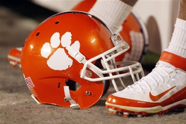 FILE - In this Dec. 3, 2011, file photo, a Clemson football helmet rests on the sidelines during the second half of an NCAA college football game against Virginia Tech in Charlotte, N.C. John Antonio, the man who designed Clemson's tiger paw logo, died Thursday, May 30, 2013, in Greenville, S.C., after a long battle with cancer, the university said. He was 83.  (AP Photo/Bob Leverone, File)