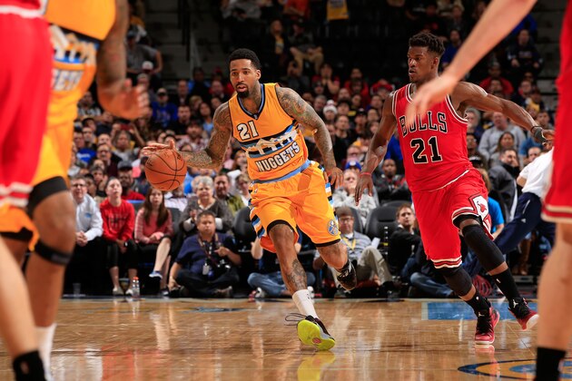 DENVER, CO - NOVEMBER 25:  Wilson Chandler #21 of the Denver Nuggets controls the ball against Jimmy Butler #21 of the Chicago Bulls at Pepsi Center on November 25, 2014 in Denver, Colorado. The Nuggets defeated the Bulls 114-109. NOTE TO USER: User expressly acknowledges and agrees that, by downloading and or using this photograph, User is consenting to the terms and conditions of the Getty Images License Agreement.  (Photo by Doug Pensinger/Getty Images)
