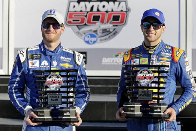 Dale Earnhardt Jr., left, and Chase Elliott display their front row trophies after qualifying for the top two positions in the NASCAR Daytona 500 auto race at Daytona International Speedway, Sunday, Feb. 19, 2017, in Daytona Beach, Fla. (AP Photo/Terry Renna)