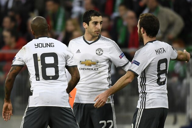 Manchester's United's Armenian forward Henrikh Mkhitaryan (C) celebrates with teammates Spanish midfielder Juan Mata (R) and British midfielder Ashley Young (L) after scoring a goal during the UEFA Europa League football match between AS Saint-Etienne and Manchester United on February 22, 2017, at the Geoffroy Guichard stadium in Saint-Etienne, central France. / AFP / PHILIPPE DESMAZES        (Photo credit should read PHILIPPE DESMAZES/AFP/Getty Images)