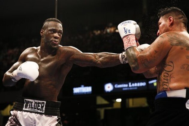 Deontay Wilder, left, punches Chris Arreola, right, during the WBC heavyweight boxing match, Saturday, July 16, 2016, in Birmingham, Ala. (AP Photo/Brynn Anderson)