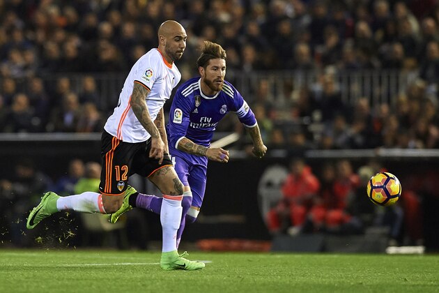 VALENCIA, SPAIN - FEBRUARY 22:  Simone Zaza (L) of Valencia competes for the ball with Sergio Ramos of Real Madrid during the La Liga match between Valencia CF and Real Madrid at Mestalla Stadium on February 22, 2017 in Valencia, Spain.  (Photo by Manuel Queimadelos Alonso/Getty Images)