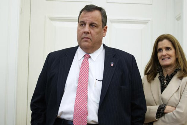 FILE- In this Tuesday, Feb. 14, 2017, file photo, New Jersey Gov. Chris Christie and his wife Mary Pat Christie watch as President Donald Trump signs House Joint Resolution 41 in the Oval Office of the White House in Washington. The state Chamber of Commerce’s 80th annual trip, nicknamed the “Walk to Washington” because rail riders generally pace the train’s corridors schmoozing and handing out business cards, on Thursday, Feb. 16, comes after a national election that hinged in part on repudiating insiders and establishment politics. Christie is set to deliver the keynote address to the gathering. (AP Photo/Evan Vucci, File)