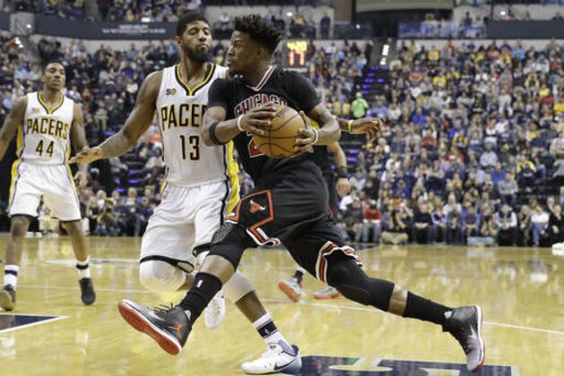 Chicago Bulls' Jimmy Butler drives past Indiana Pacers' Paul George during the second half of an NBA basketball game Friday, Dec. 30, 2016, in Indianapolis. Indiana defeated Chicago 111-101. (AP Photo/Darron Cummings)