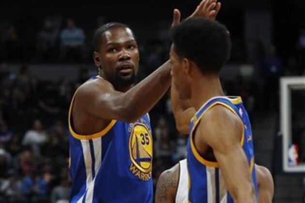 Golden State Warriors forward Kevin Durant (35) and Golden State Warriors guard Patrick McCaw (0) in the first half of an NBA basketball game Monday, Feb. 13, 201, in Denver. (AP Photo/David Zalubowski)