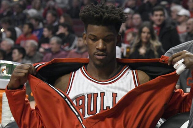 Chicago Bulls forward Jimmy Butler sits on the bench during the start of the team's NBA basketball game against the Miami Heat in Chicago, Friday, Jan. 27, 2017. Butler was taken out of the starting lineup for comments he made after a Bulls loss. (AP Photo/David Banks)