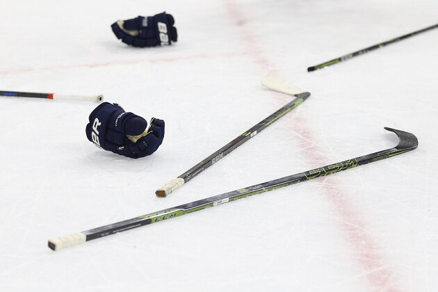 PHILADELPHIA, PA - OCTOBER 12: A detailed view of hockey sticks and gloves following a scrum during an NHL game at Wells Fargo Center on October 12, 2015 in Philadelphia, Pennsylvania. (Photo by Patrick Smith/Getty Images)