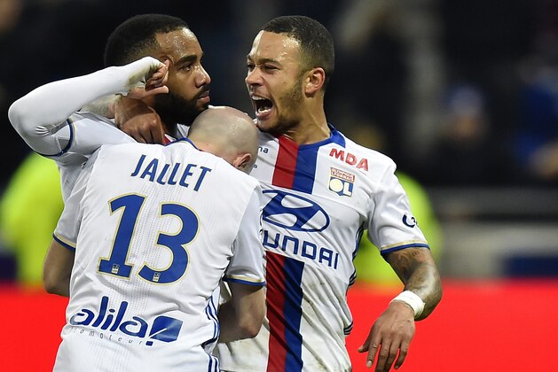 Lyon's French forward Alexandre Lacazette (L) celebrates after scoring a goal with teammates Lyon's French defender Christophe Jallet (C) and Lyon's Dutch forward Memphis Depay during the French L1 football match between Olympique Lyonnais (OL) and Dijon (DFCO) on February 19, 2017, at the Parc Olympique Lyonnais stadium in Decines-Charpieu near Lyon, central-eastern France. / AFP / ROMAIN LAFABREGUE        (Photo credit should read ROMAIN LAFABREGUE/AFP/Getty Images)