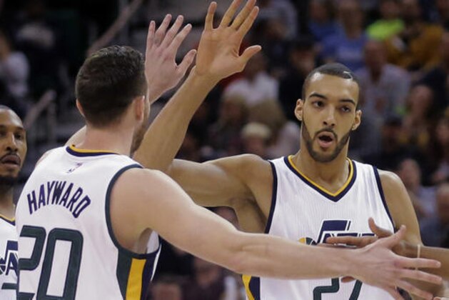 Utah Jazz's Rudy Gobert (27) and Gordon Hayward (20) high-five during the first half of an NBA basketball game against the Portland Trail Blazers Wednesday, Feb. 15, 2017, in Salt Lake City. (AP Photo/Rick Bowmer)
