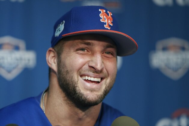 New York Mets outfielder and former NFL quarterback Tim Tebow laughs during a news conference at the baseball teams spring training facility in Port St. Lucie, Fla., Monday, Feb. 27, 2017. (AP Photo/John Bazemore)
