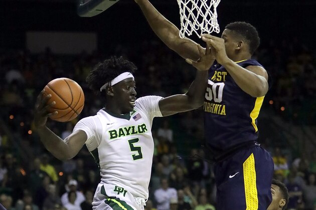 WACO, TX - FEBRUARY 27:  Johnathan Motley #5 of the Baylor Bears passes the ball in front of Sagaba Konate #50 of the West Virginia Mountaineers in the second half at Ferrell Center on February 27, 2017 in Waco, Texas.  (Photo by Ronald Martinez/Getty Images)
