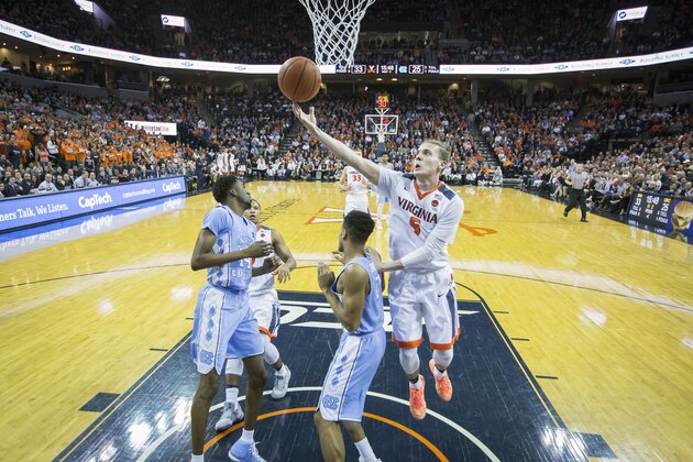 CHARLOTTESVILLE, VA - FEBRUARY 27: Kyle Guy #5 of the Virginia Cavaliers rebounds the ball over Nate Britt #0 of the North Carolina Tar Heels during a game at John Paul Jones Arena on February 27, 2017 in Charlottesville, Virginia. (Photo by Chet Strange/Getty Images)